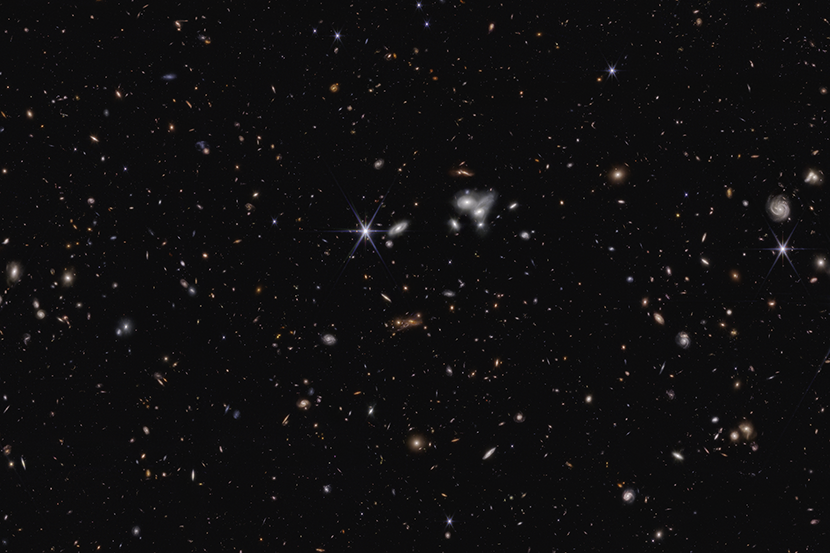Stars and galaxies dot the black background of space