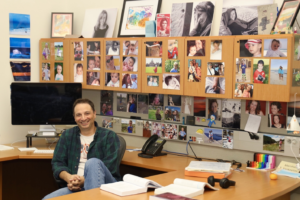 tom yankeelov in his office with photos and drawings of his family filling the cabinet walls
