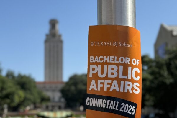 burnt orange poster in view of UT Tower