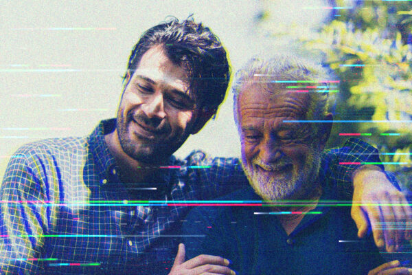 On the left, a younger man with dark hair and a beard sits beside an older man with white hair. The younger man has his arm around the shoulders of the older man. Overlaid on the image are digital distortion lines.