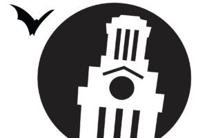 A pumpkin carving stencil shows an illustration of the U.T. Tower and two bats flying above it.