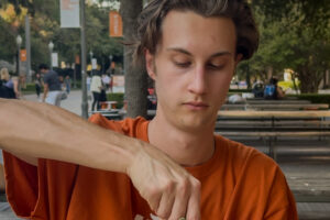 A U.T. Austin student carving a Longhorn themed jack-o’-lantern.