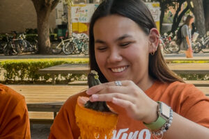 A U.T. Austin student carving a Longhorn themed jack-o’-lantern.