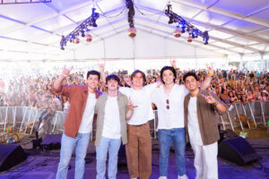 West 22nd, a band of U.T. Austin students, pose for a group picture on stage at the Austin City Limits Music Festival in October 2024.