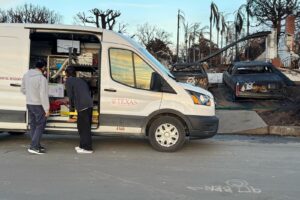 Two people looking into a white van