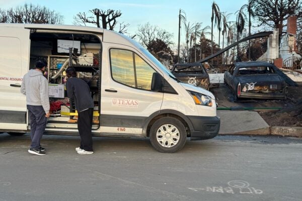 Two people looking into a white van