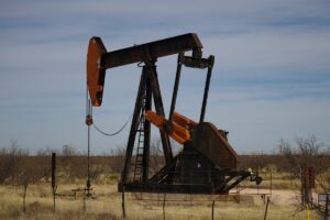 A black and red pumping unit in a West Texas oil field