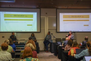 An audience of faculty and staff learn about AI use at UT Austin