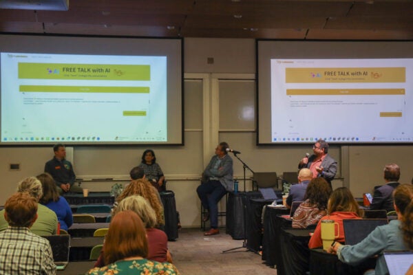 An audience of faculty and staff learn about AI use at UT Austin