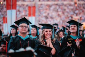 Three master's degree graduates at The University of Texas at Austin's 2025 University-Wide Commencement Ceremony