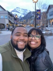 Couple smiling with mountains in the background