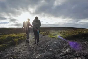 Two people walking on a trail in Ireland