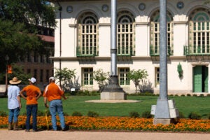 Three landscapers working on the grounds of the University of Texas at Austin campus