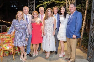 Young family stands together at evening event