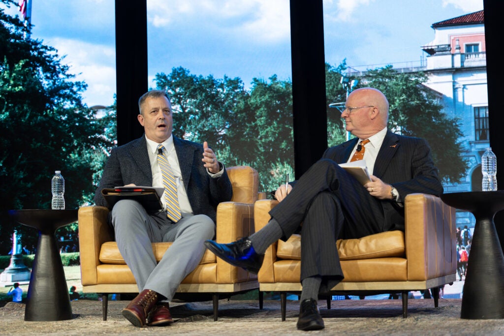 Provost Inboden and Paul Edgar sit, talking together on stage