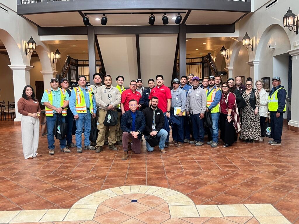 Early responders stand together posing for photo