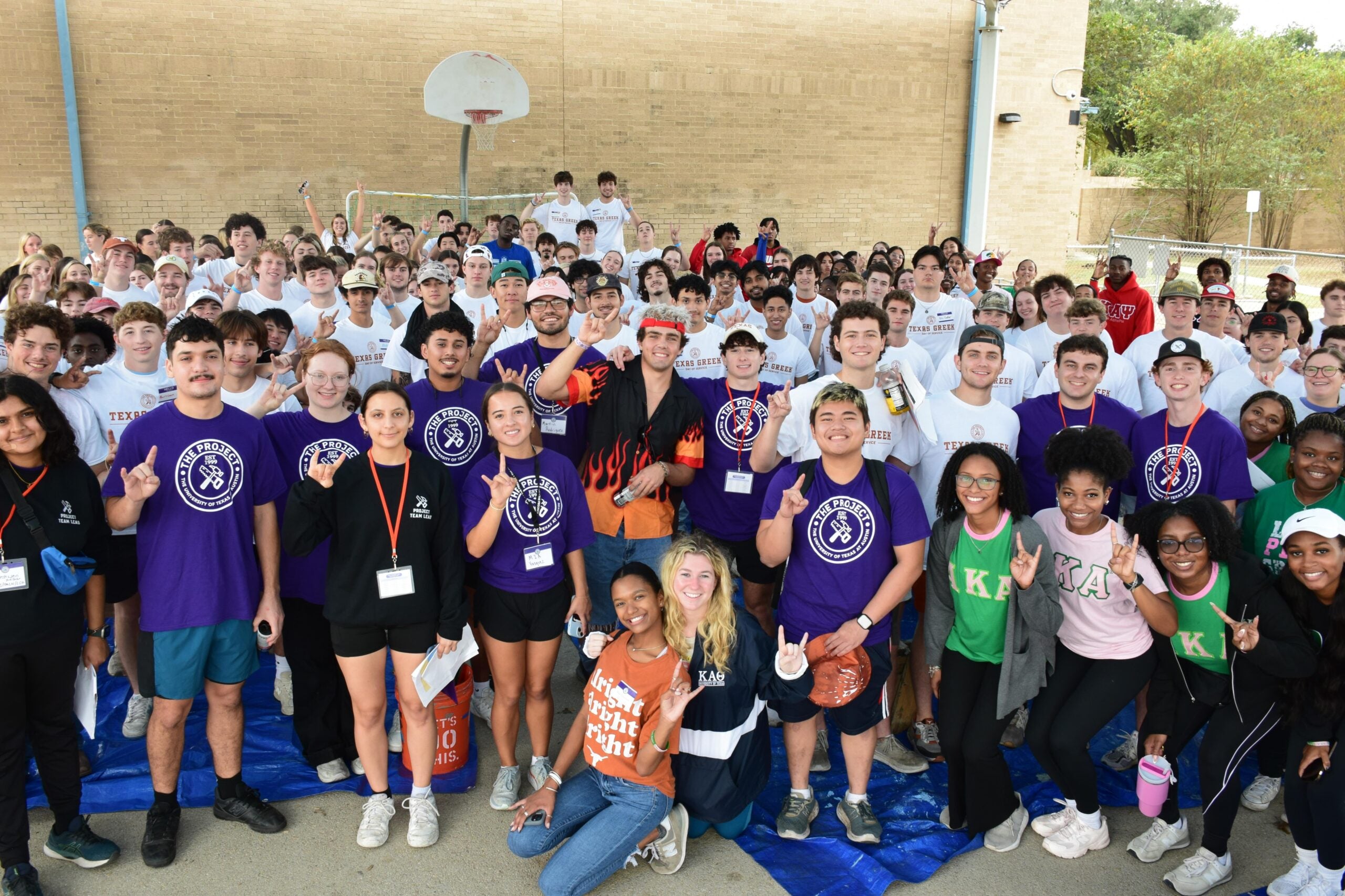 Students pose while volunteering