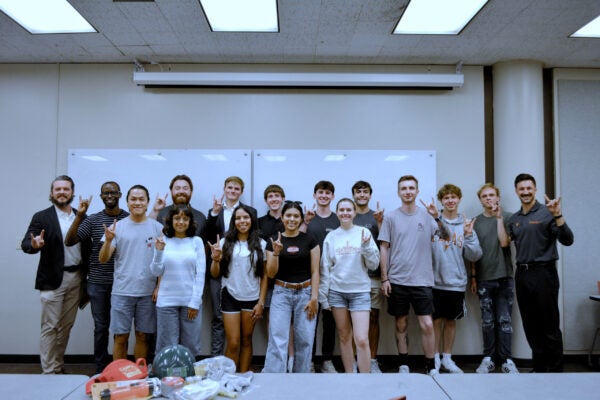A group of students posing for a photo in a classroom.