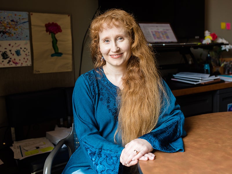 Woman sits at table