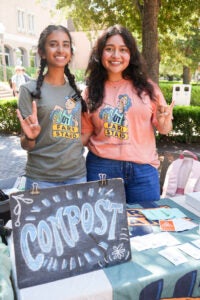 Two students tabling on a college campus