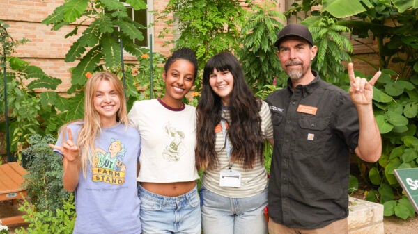 A group of people poses for a photo in a garden