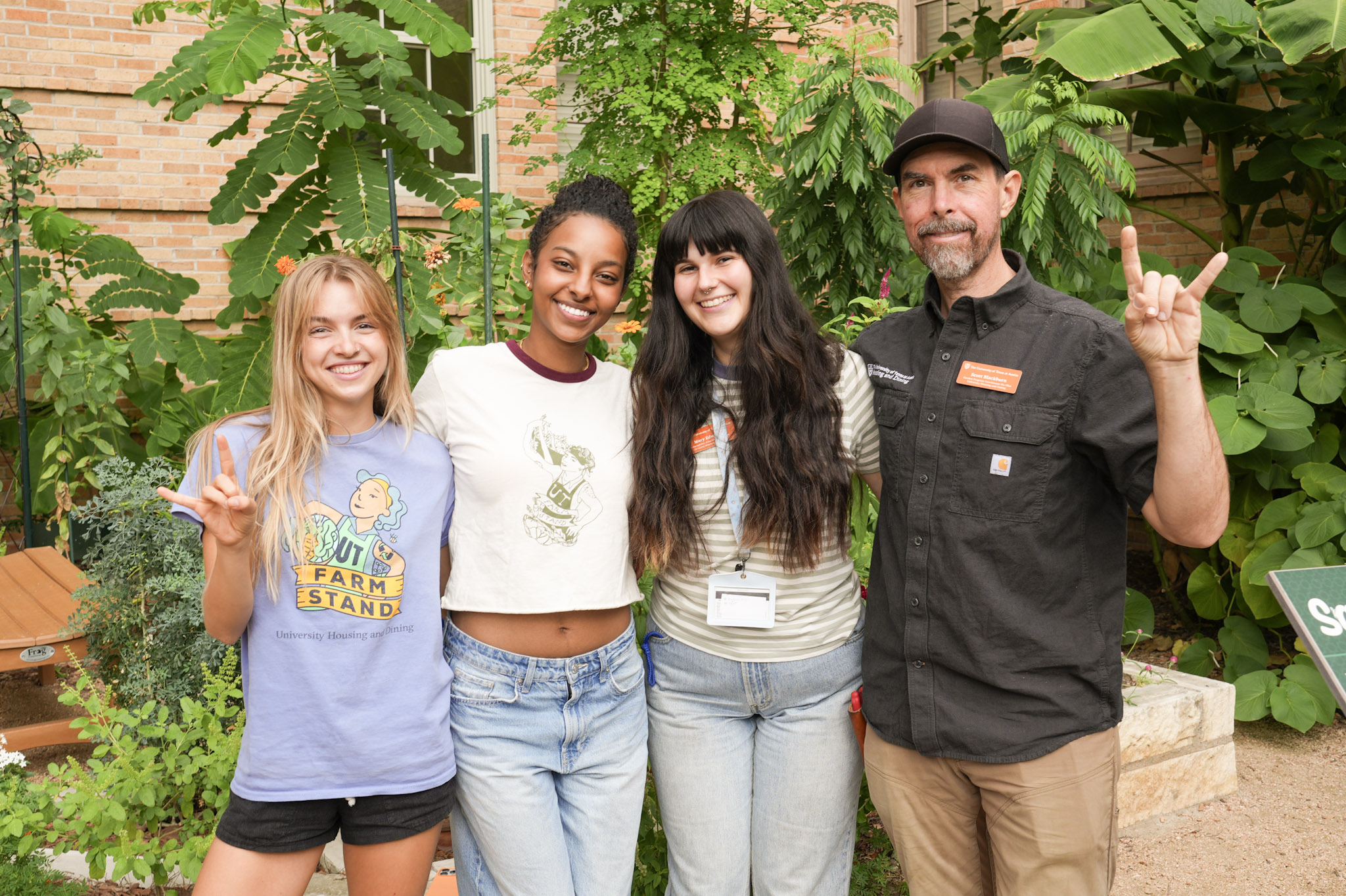 A group of people poses for a photo in a garden
