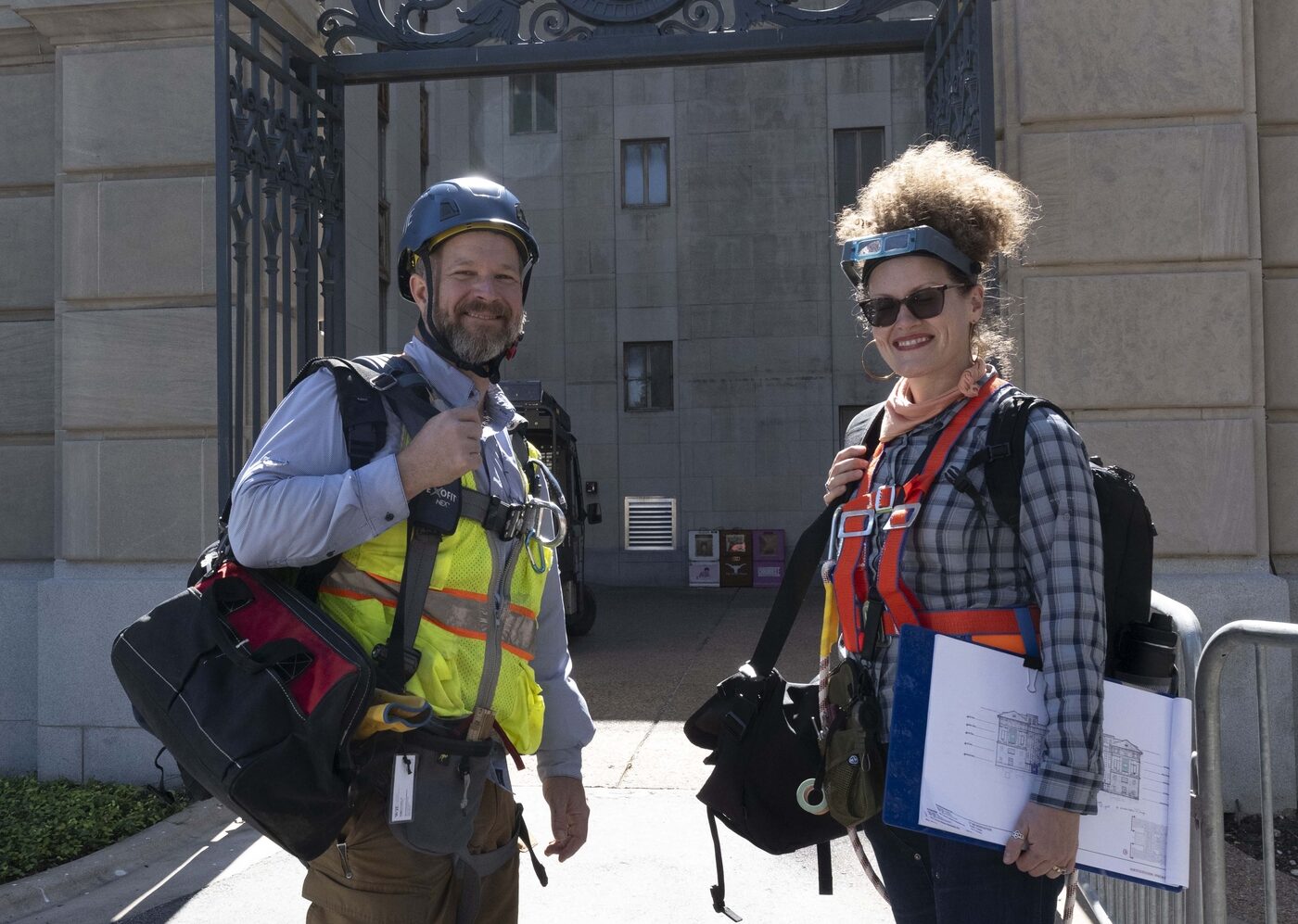 Man and woman in construction garb smiling