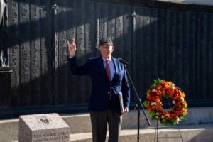 Man in suit speaks to crowd