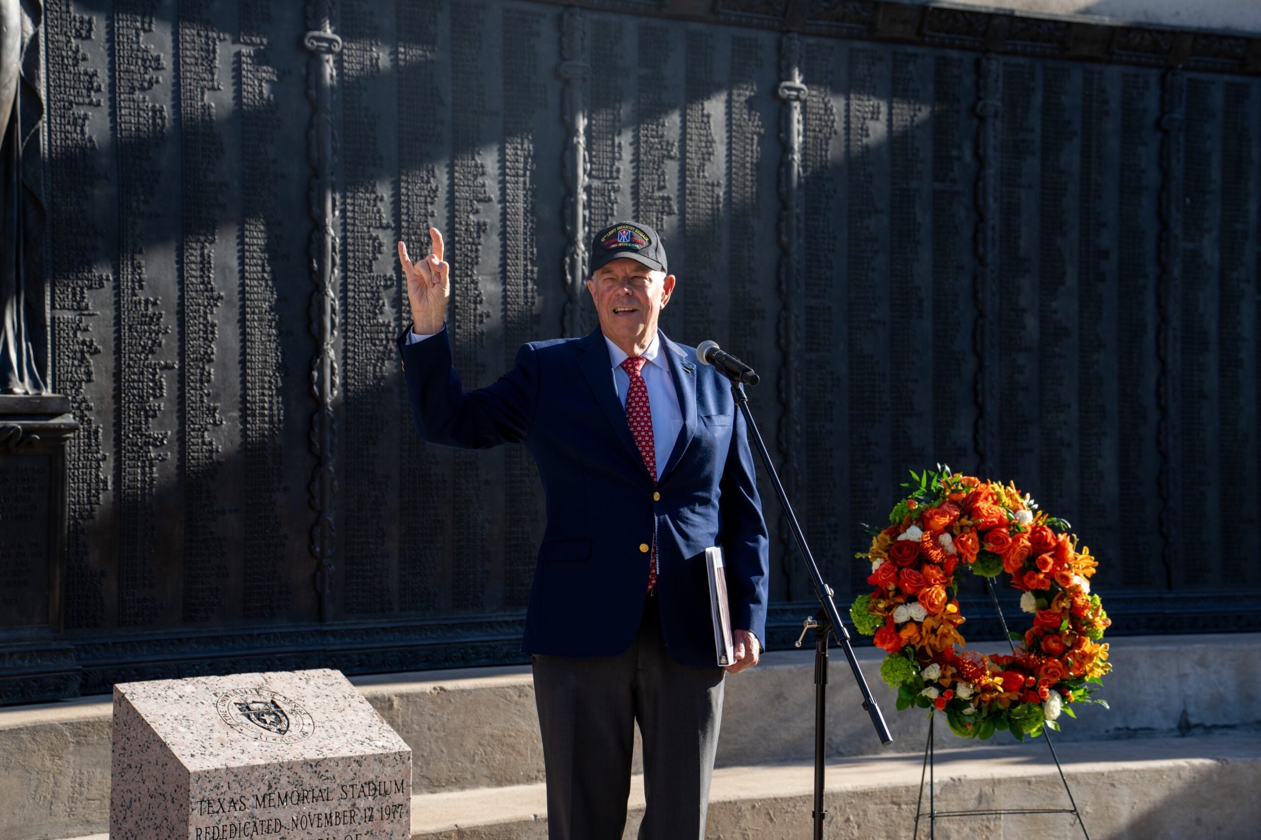Man in suit speaks to crowd
