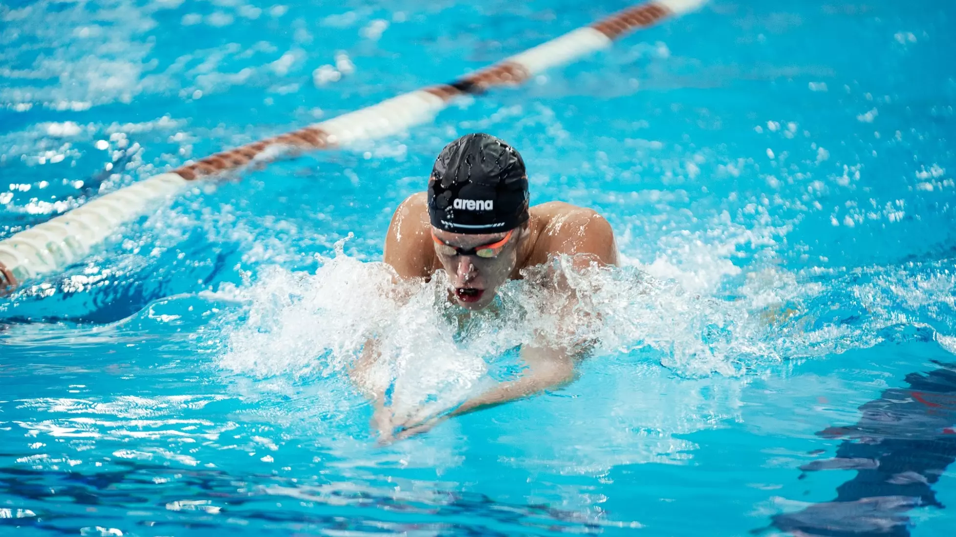 A male swimmer doing breast stroke