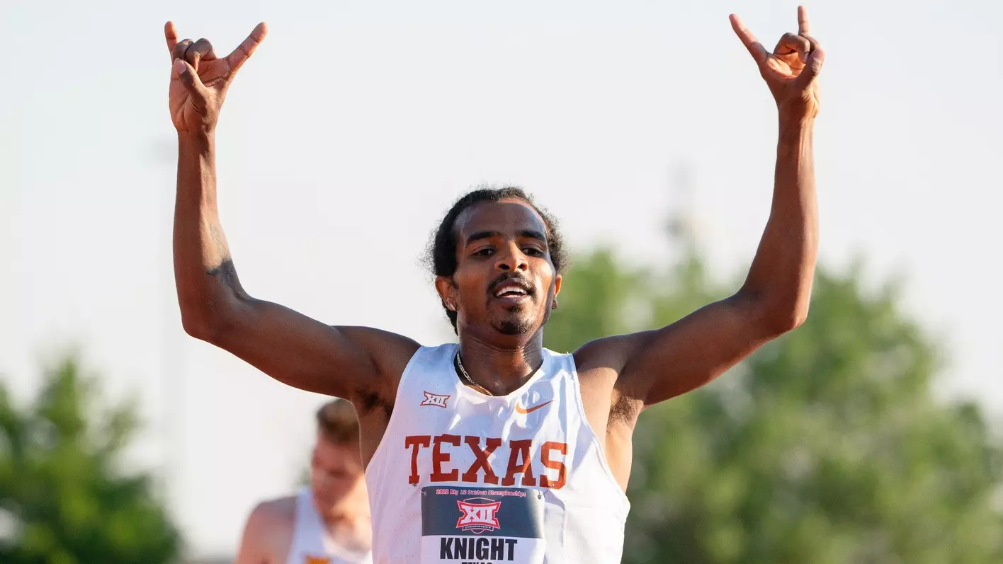 man running with white TEXAS muscle dirt and doing Hookem sign with both upraised hands