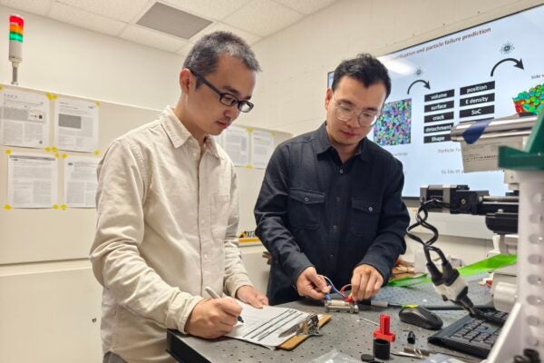 Researchers Guannan Qian, left, and Tianxio Sun investigate battery performance in a laboratory at the Cockrell School of Engineering’s Walker Department of Mechanical Engineering.