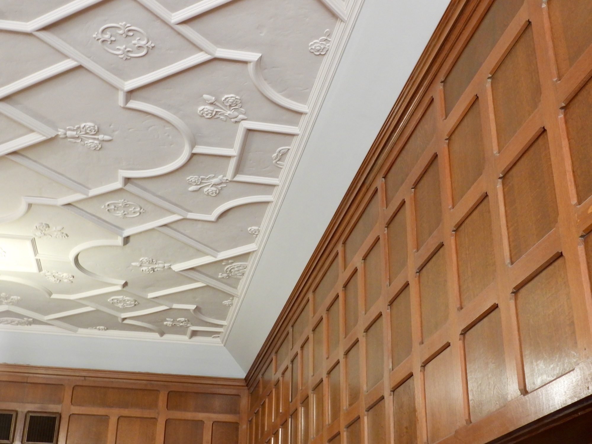 Tudor style plaster ceiling and wood-panel walls