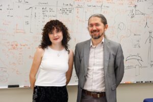 Two researchers standing in front of a whiteboard.