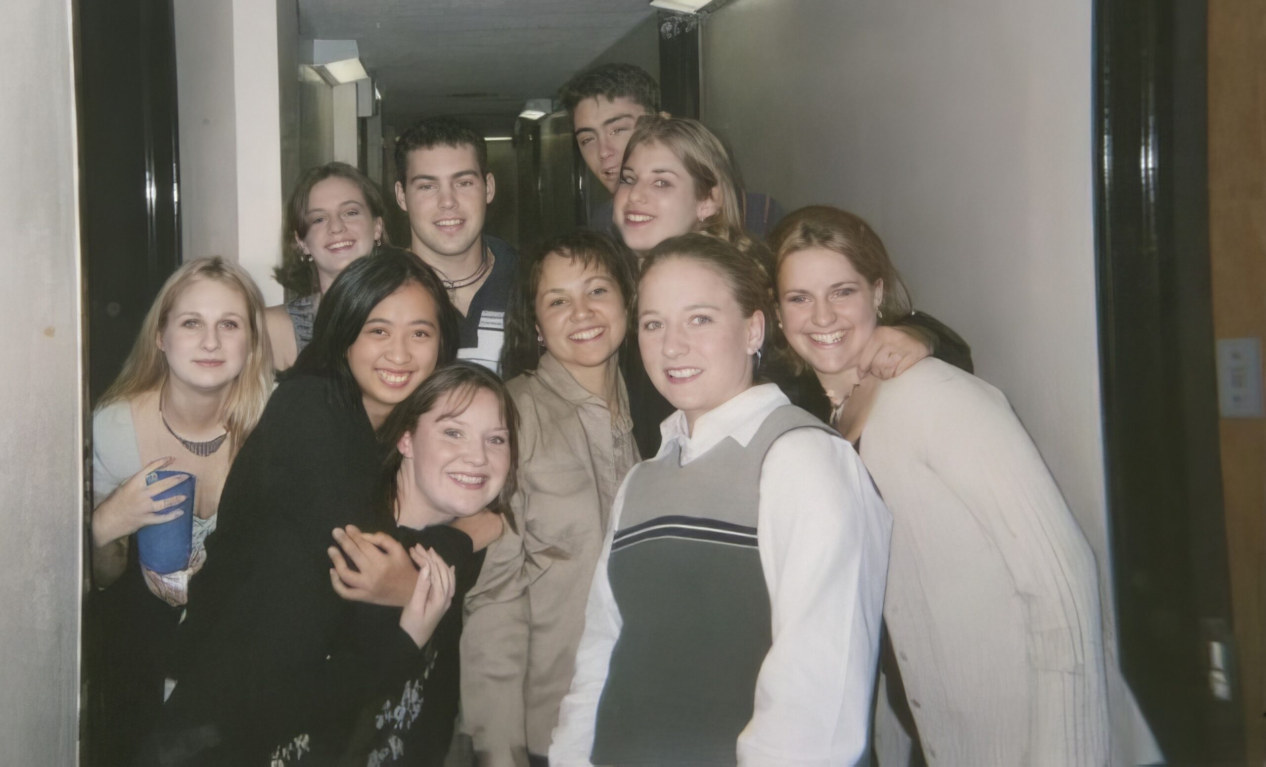 A group of students pose for a photo in a college dorm.