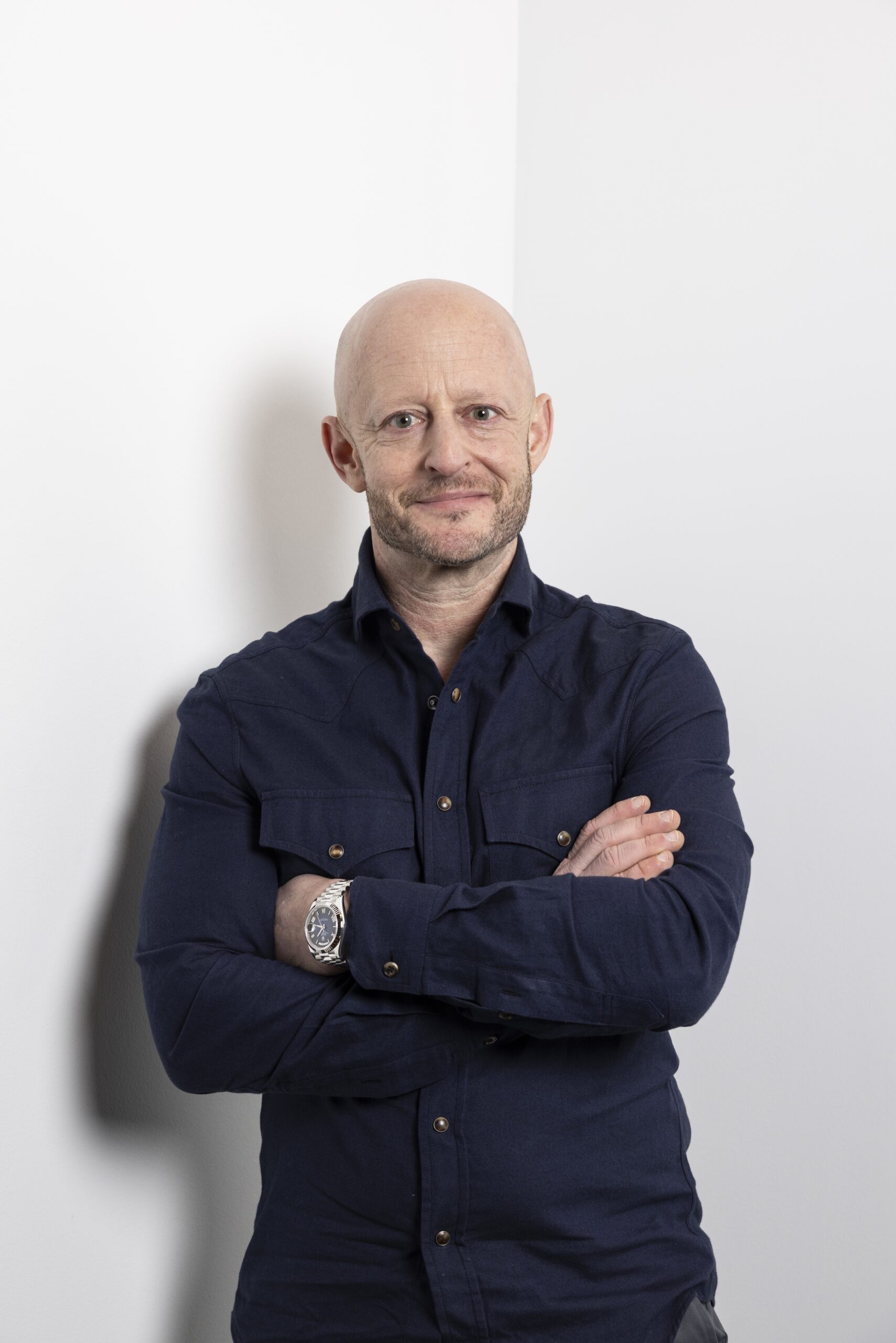Man in navy shirt with arms crossed