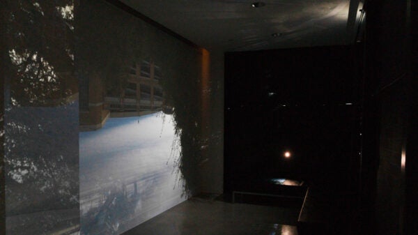 Installation image featuring a camera obscura projecting an upside down image of DKR on the inside of the Visual Arts Center