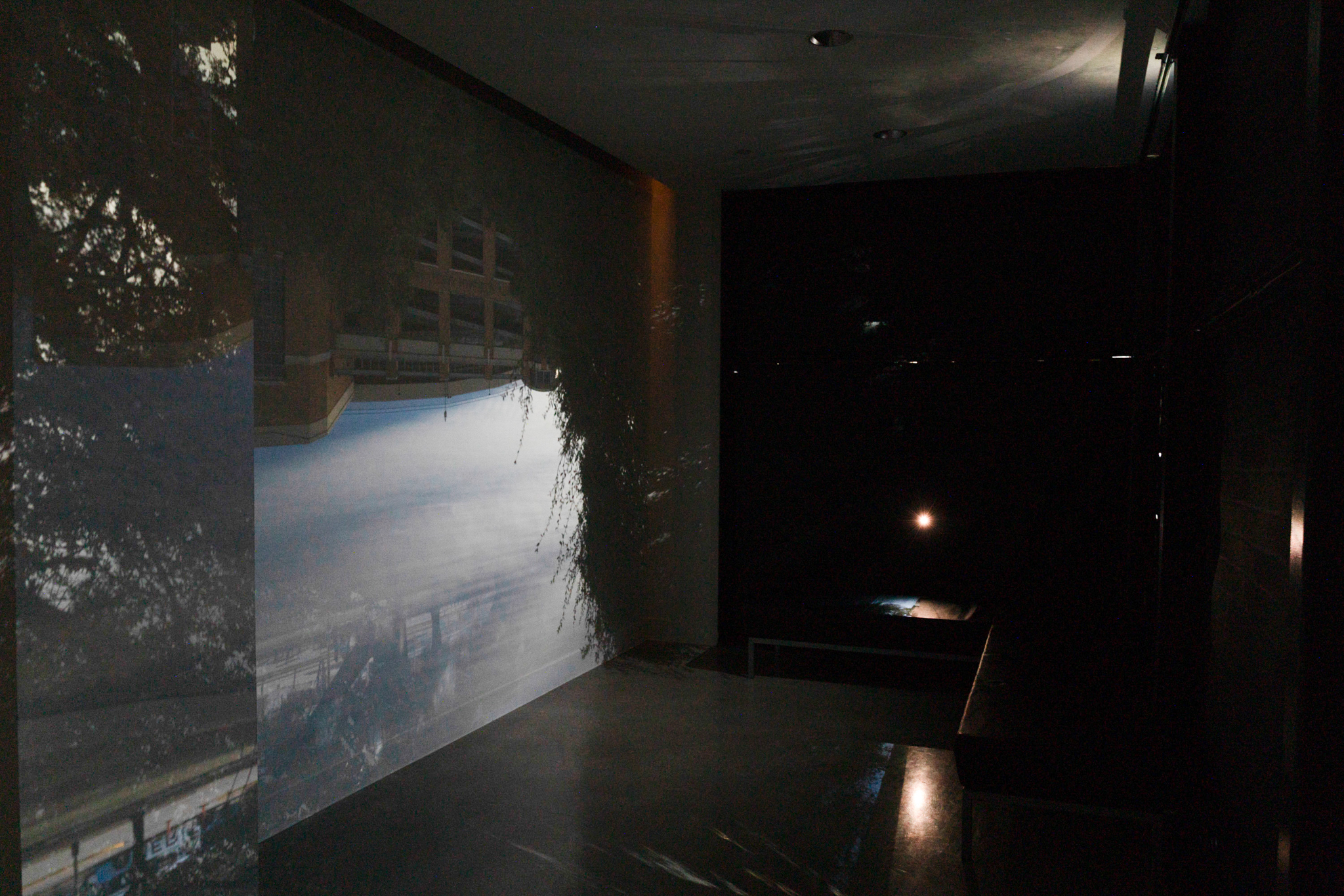 Installation image featuring a camera obscura projecting an upside down image of DKR on the inside of the Visual Arts Center