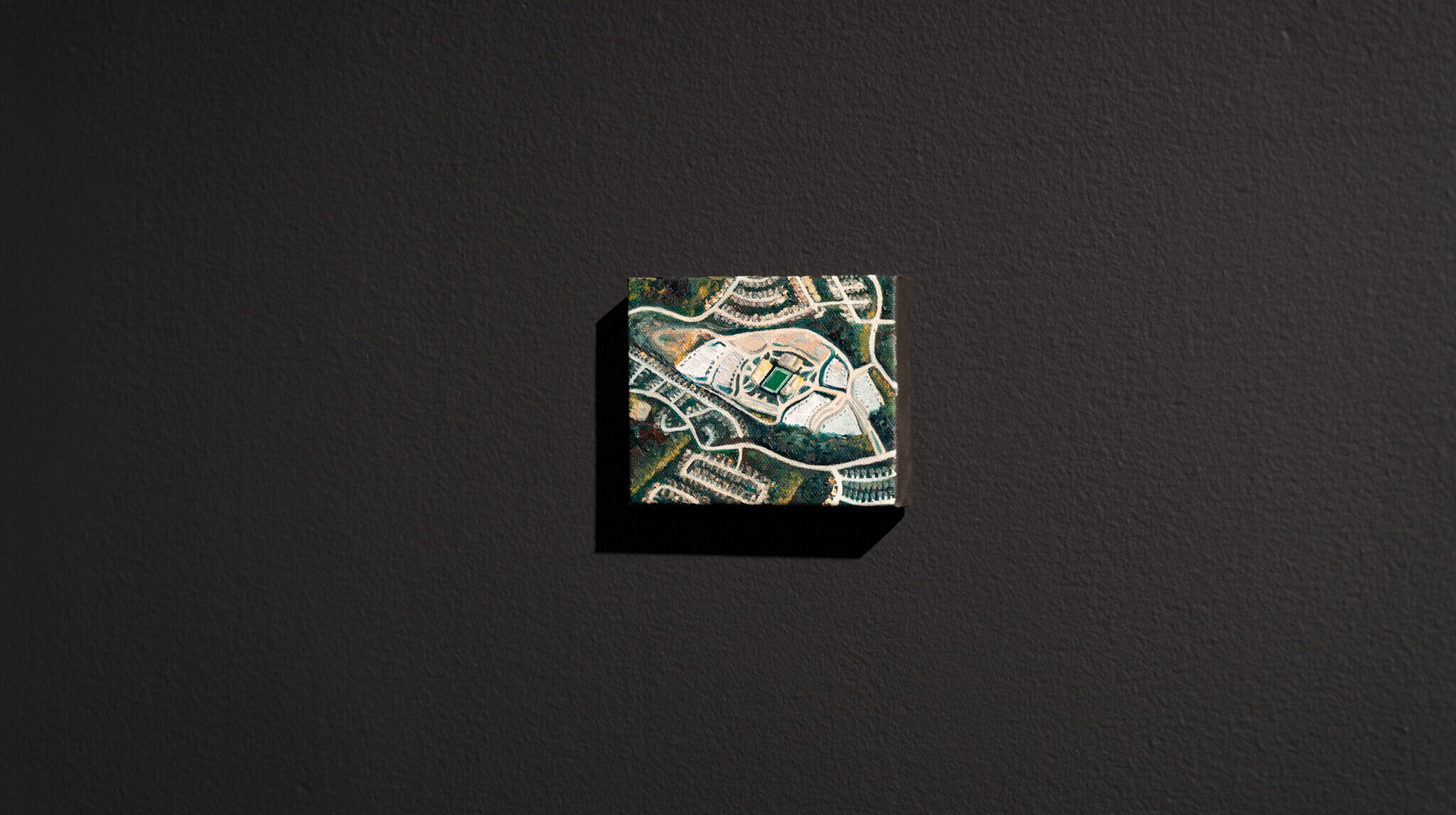 installation image of a painting of a bird's eye view of a stadium