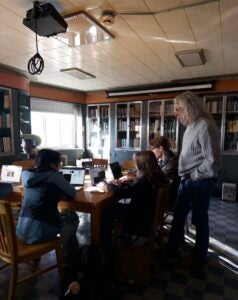 image of a professor with students in a library