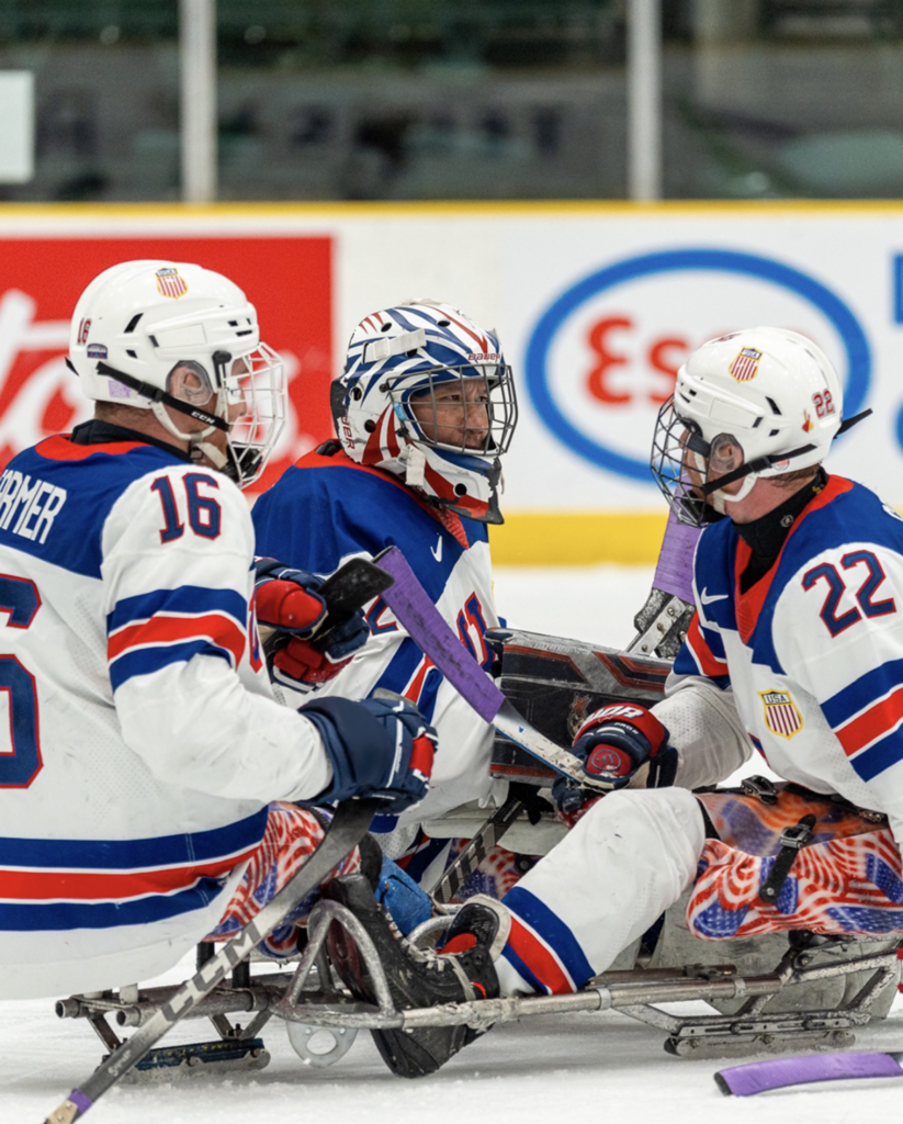 image of three sled hockey players on the ice