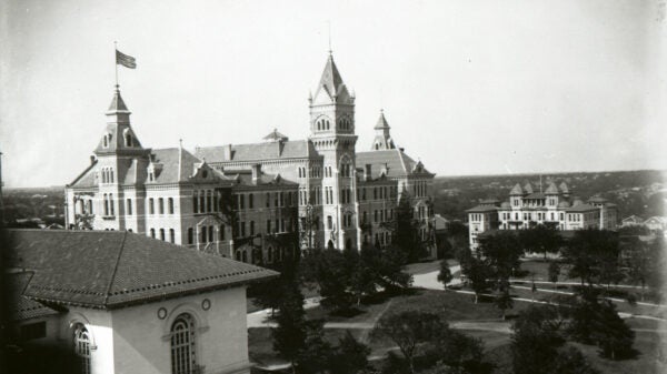 An antique image of Old Main Building at UT in black and white