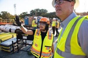 Woman in yellow vest and hardhat