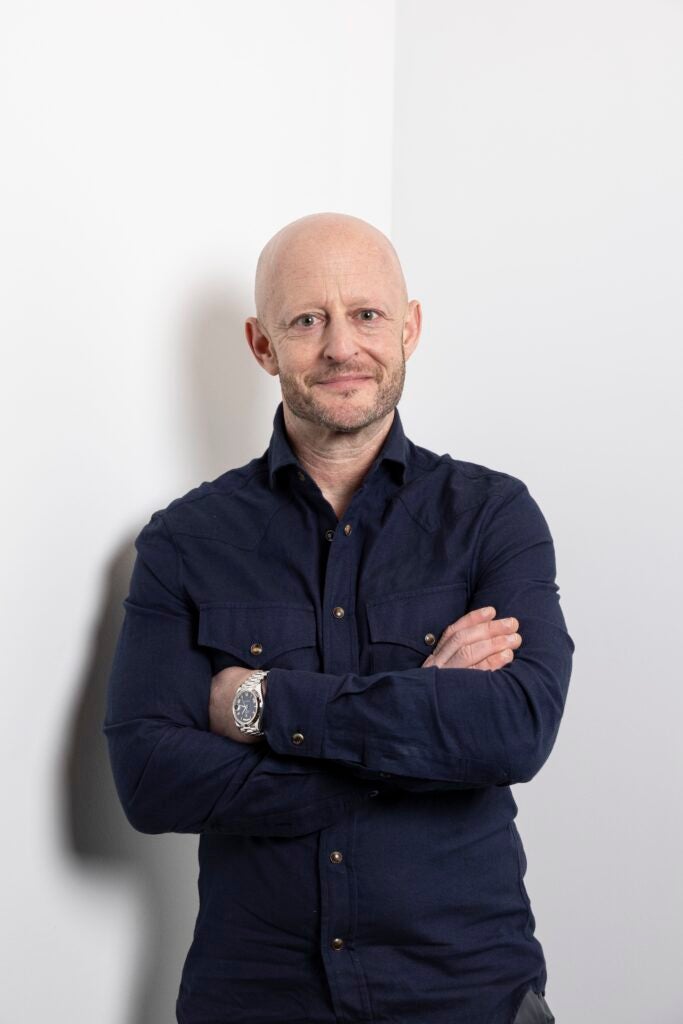 Man in navy shirt with arms crossed