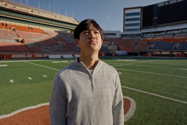 image of a student on the field at DKR looking up at the sky