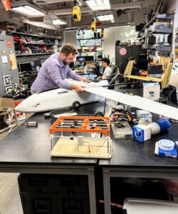 a student working on a small aircraft