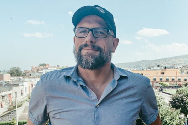 Man in blue shirt and baseball cap