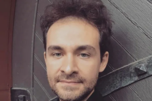 close up photo of man standing against a door