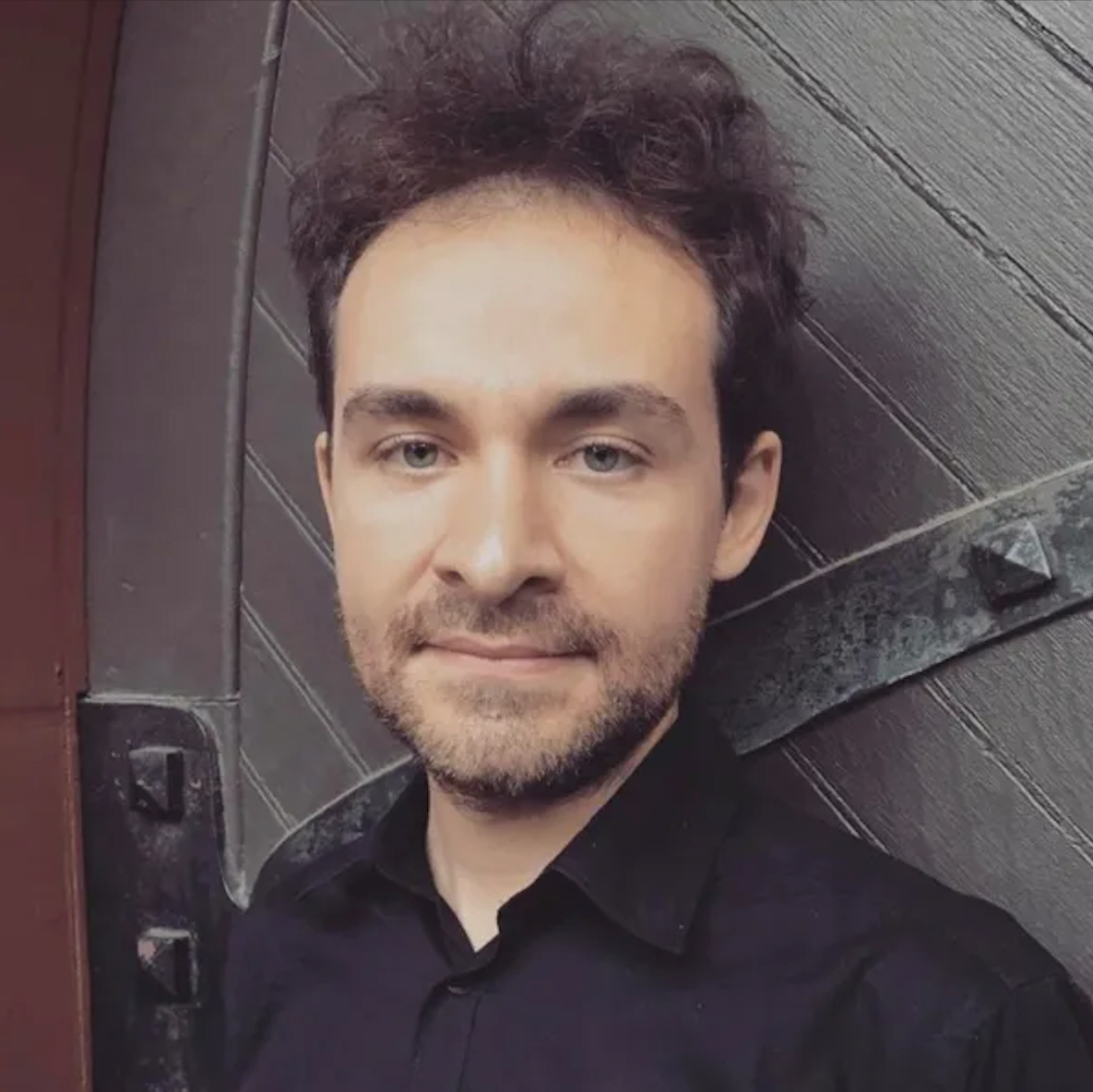 close up photo of man standing against a door