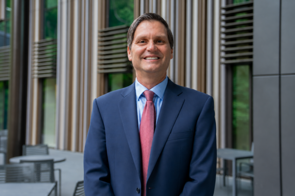 Bradley Staats poses for a headshot dressed in a suit.
